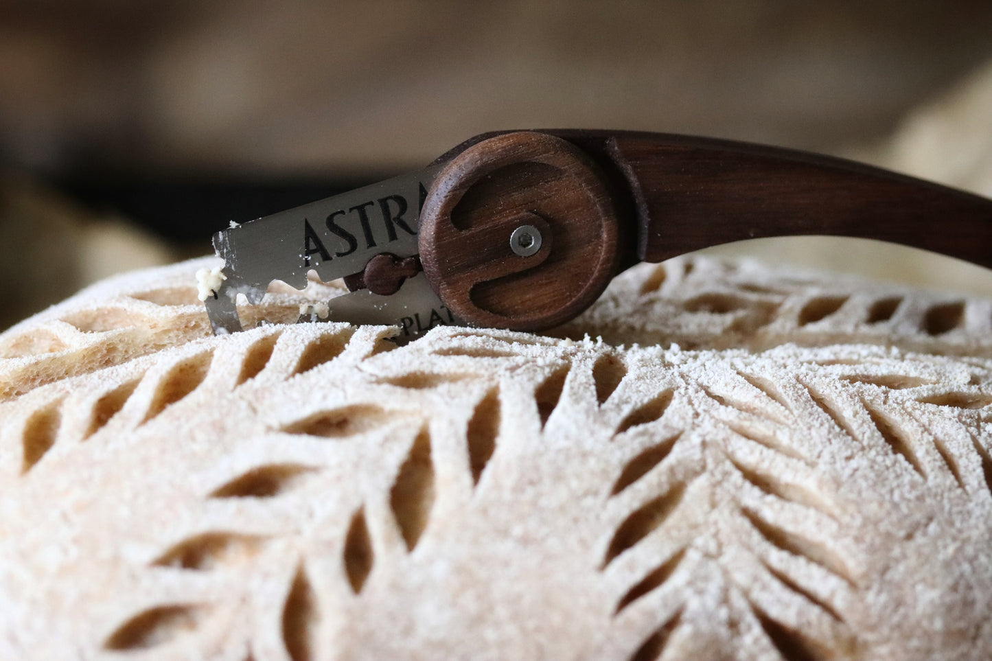 Scoring a raw sourdough boule with a Wire Monkey Goose lame